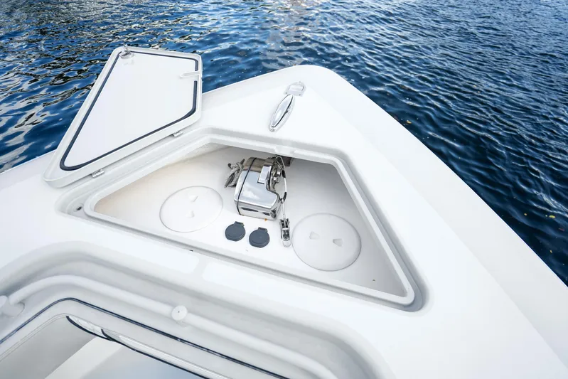 Four Reels Yacht Photos Pics Contender 44 CB 2021 boat anchor compartment with open hatch, on calm water.