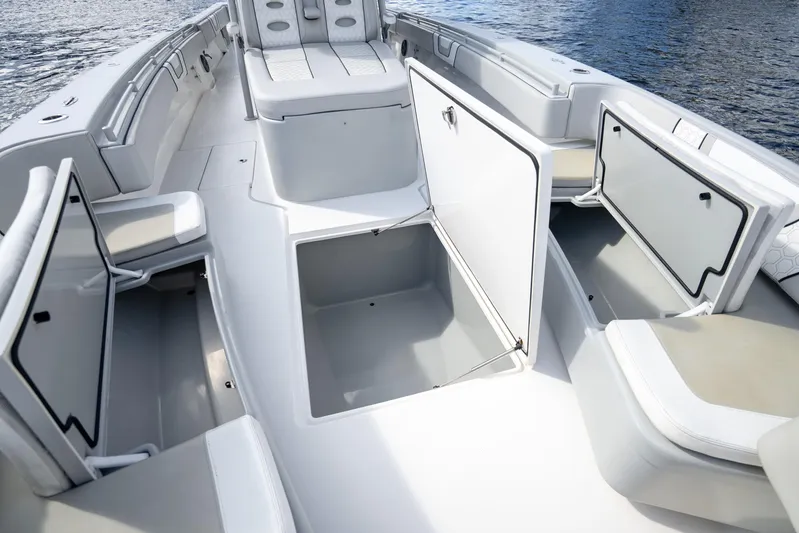 Four Reels Yacht Photos Pics 2021 Contender 44 CB boat interior with open storage compartments and seating.