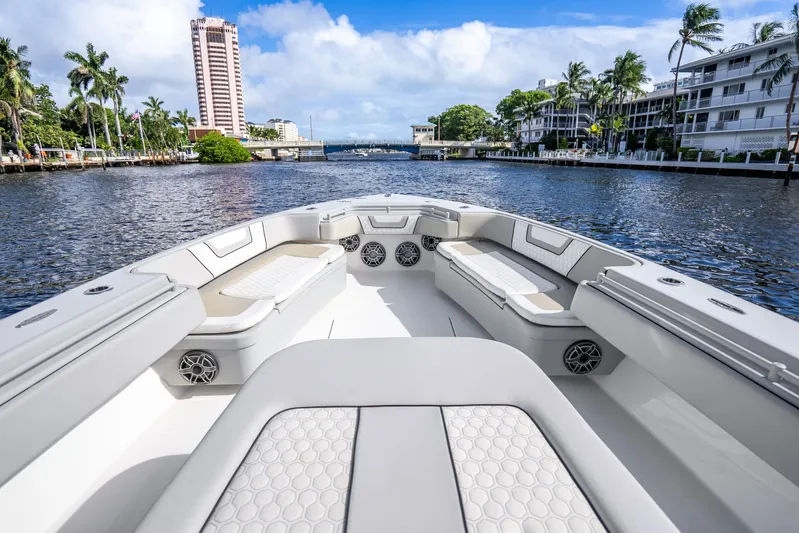 Four Reels Yacht Photos Pics 2021 Contender 44 CB boat interior with luxurious seating on a scenic waterway.