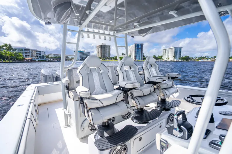 Four Reels Yacht Photos Pics 2021 Contender 44 CB boat interior with luxury seating on a sunny day.