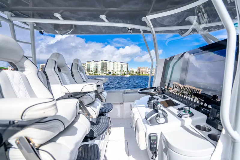 Four Reels Yacht Photos Pics 2021 Contender 44 CB boat interior with modern helm and seating, ocean view.