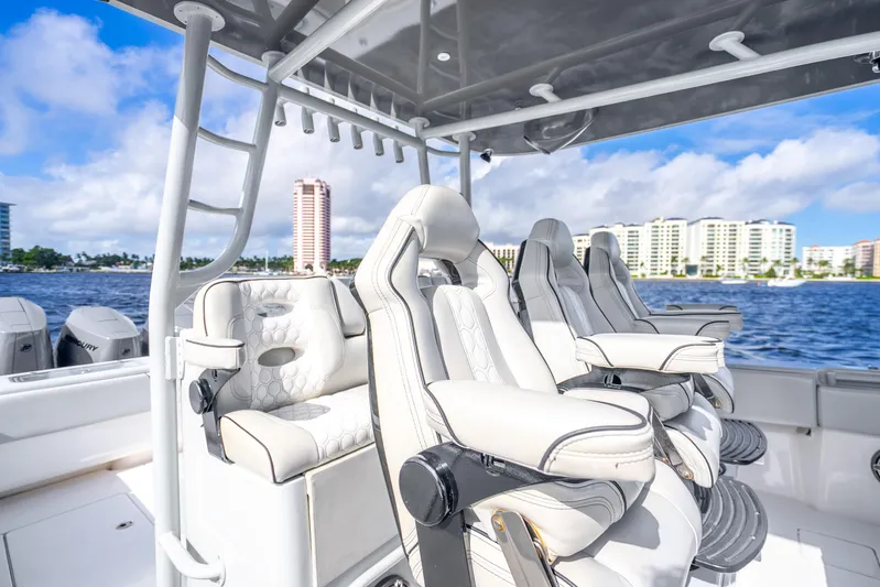 Four Reels Yacht Photos Pics 2021 Contender 44 CB boat interior with luxurious seating, ocean view, and city skyline.