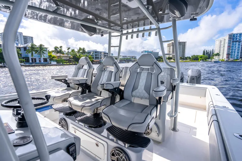 Four Reels Yacht Photos Pics Luxury seating on 2021 Contender 44 CB boat, with waterfront cityscape in background.