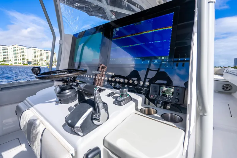Four Reels Yacht Photos Pics Helm of 2021 Contender 44 CB boat with advanced navigation system and controls.