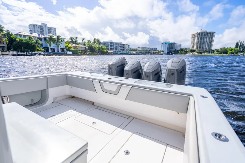 Four Reels Yacht Photos Pics 2021 Contender 44 CB boat with powerful engines on a sunny waterfront.