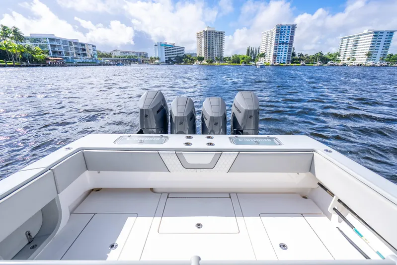 Four Reels Yacht Photos Pics Contender 44 CB 2021 boat with four engines on a sunny waterfront.