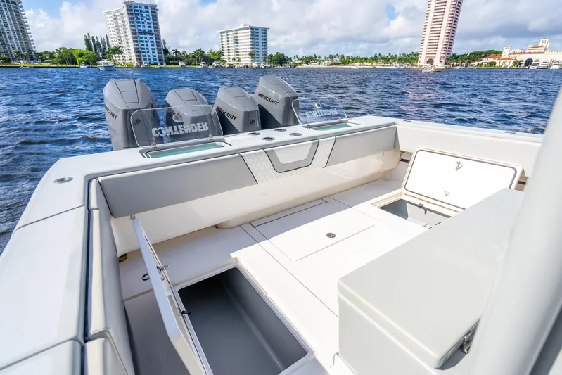 Four Reels Yacht Photos Pics 2021 Contender 44 CB boat with open storage compartments and powerful Mercury engines.