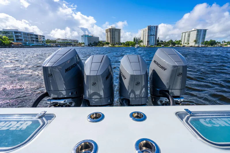 Four Reels Yacht Photos Pics Four Mercury outboard engines on a 2021 Contender 44 CB boat, cityscape in background.