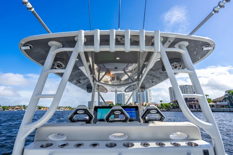 Four Reels Yacht Photos Pics Contender 44 CB 2021 boat helm with electronics, ocean view, and city skyline in background.