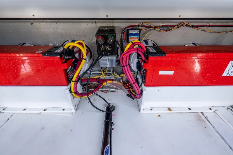 Four Reels Yacht Photos Pics Contender 44 CB 2021 boat battery compartment with wiring and red battery units.