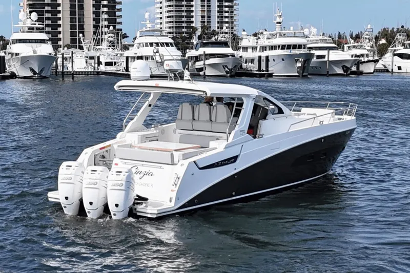 Cinza Yacht Photos Pics Azimut 40 Verve 2020 yacht cruising in a marina with luxury boats in the background.