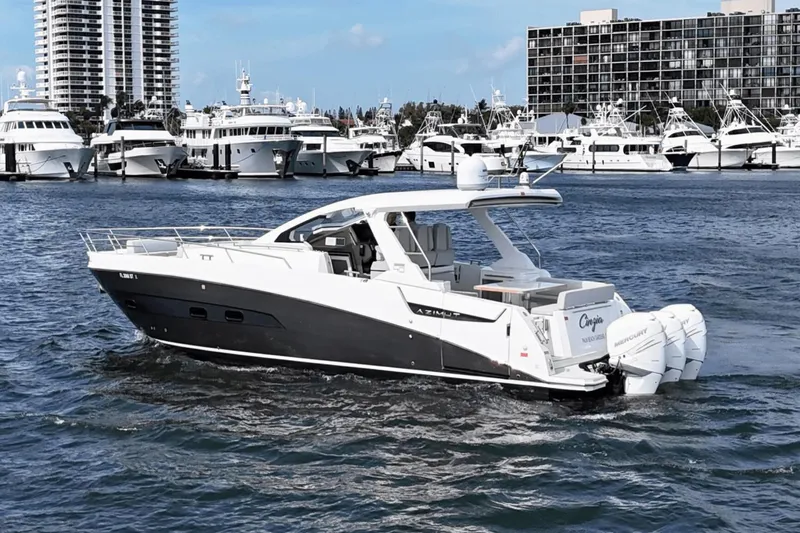 Cinza Yacht Photos Pics Azimut 40 Verve 2020 yacht cruising in a marina with luxury boats in the background.