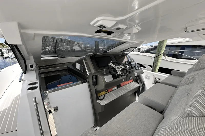 Cinza Yacht Photos Pics Helm of 2020 Azimut 40 Verve yacht with modern controls and seating.