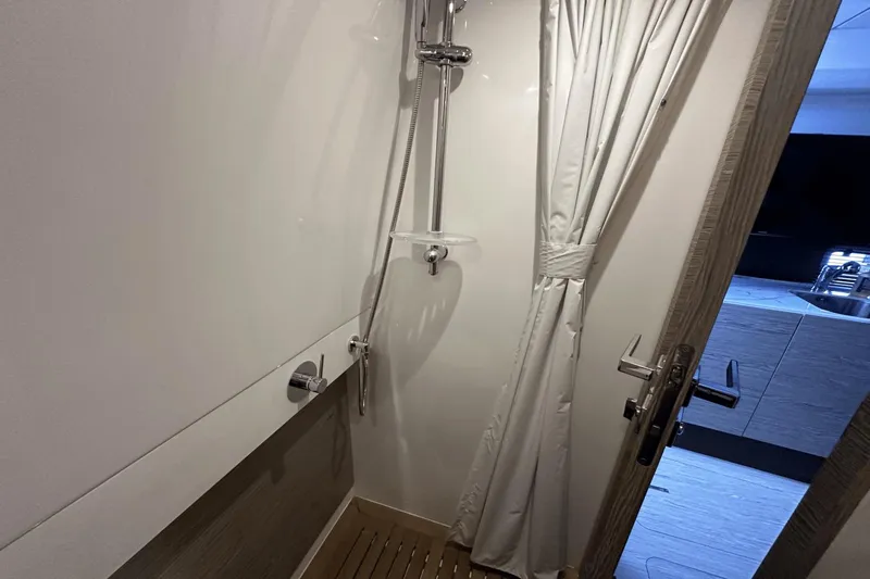 Cinza Yacht Photos Pics Shower area in 2020 Azimut 40 Verve yacht, featuring modern fixtures and curtain.