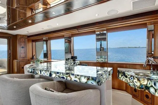 Danielle Yacht Photos Pics Luxurious interior of 2005 Hatteras 100 Motor Yacht with ocean view and elegant decor.