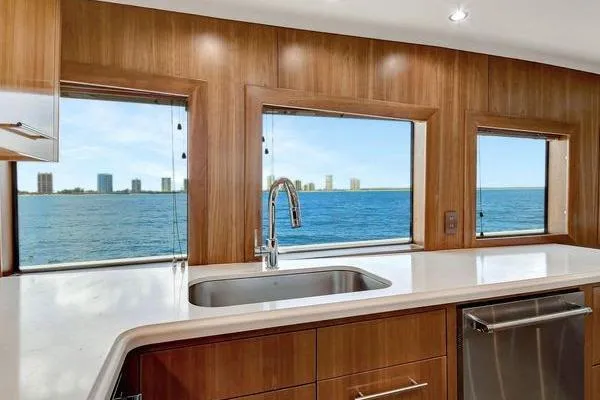 Danielle Yacht Photos Pics Luxurious kitchen view from 2005 Hatteras 100 Motor Yacht, featuring ocean and skyline.