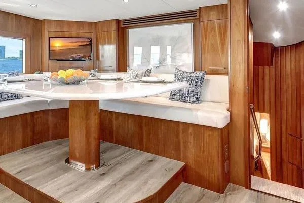 Danielle Yacht Photos Pics Luxurious dining area in 2005 Hatteras 100 Motor Yacht with elegant wood finish.