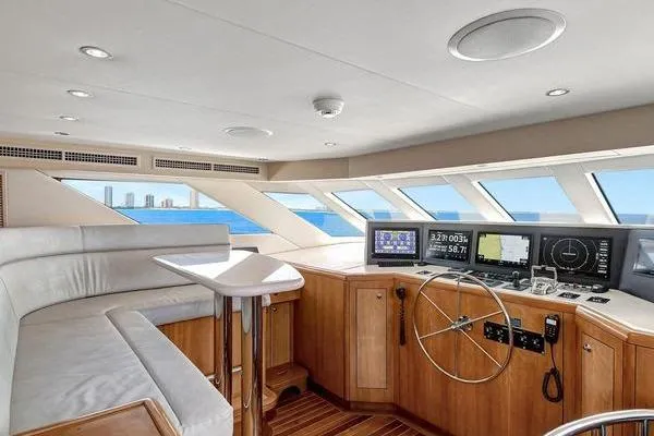 Danielle Yacht Photos Pics Interior helm of 2005 Hatteras 100 Motor Yacht with modern navigation equipment and panoramic windows.