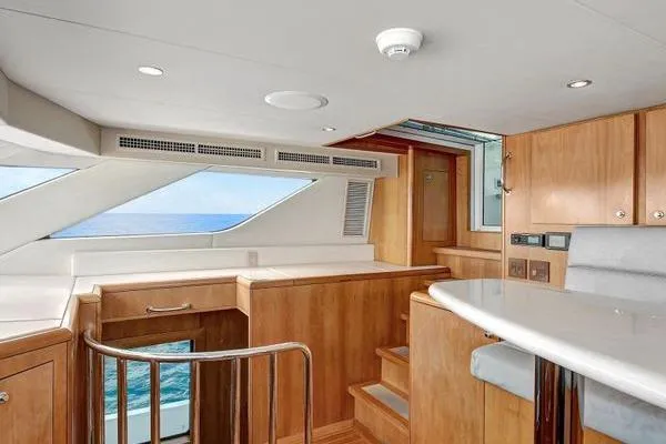 Danielle Yacht Photos Pics Interior of 2005 Hatteras 100 Motor Yacht with wooden cabinetry and ocean view.