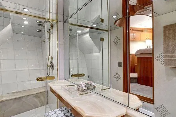 Danielle Yacht Photos Pics Luxurious bathroom in 2005 Hatteras 100 Motor Yacht with elegant fixtures and mirrored walls.