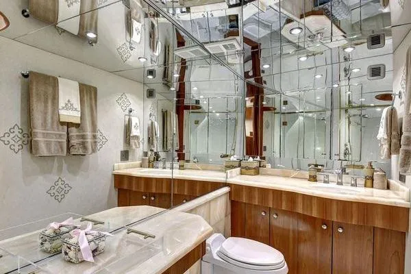 Danielle Yacht Photos Pics Luxurious bathroom in 2005 Hatteras 100 Motor Yacht with mirrored walls and elegant fixtures.