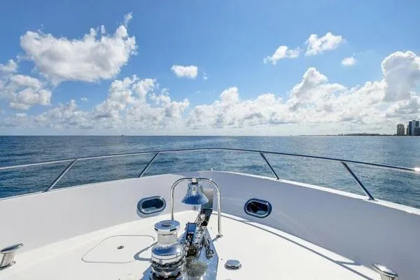 Danielle Yacht Photos Pics Bow view of 2005 Hatteras 100 Motor Yacht on open sea under blue sky.