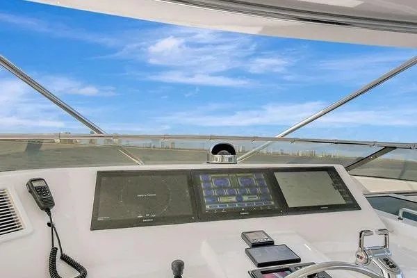 Danielle Yacht Photos Pics Helm of 2005 Hatteras 100 Motor Yacht with navigation equipment and ocean view.