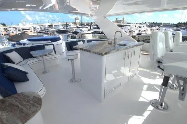 Danielle Yacht Photos Pics Luxurious 2005 Hatteras 100 Motor Yacht deck with seating and bar area.
