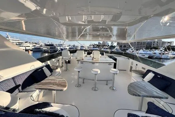 Danielle Yacht Photos Pics Luxurious 2005 Hatteras 100 Motor Yacht interior with elegant seating and marina view.