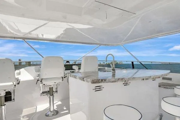 Danielle Yacht Photos Pics Luxurious 2005 Hatteras 100 Motor Yacht with elegant outdoor seating and ocean view.