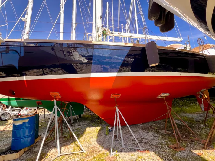 Glory Yacht Photos Pics 2001 Shannon 43 Cutter sailboat on stands, vibrant red hull, marina setting.