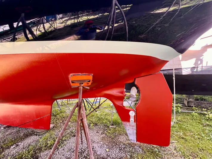 Glory Yacht Photos Pics Red hull of 2001 Shannon 43 Cutter sailboat on stands, showing keel and rudder.