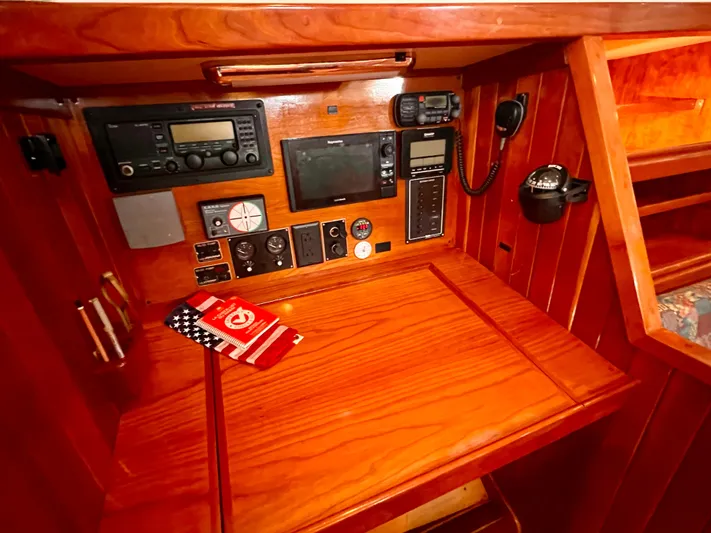 Glory Yacht Photos Pics Navigation station of 2001 Shannon 43 Cutter with communication equipment and wooden finish.