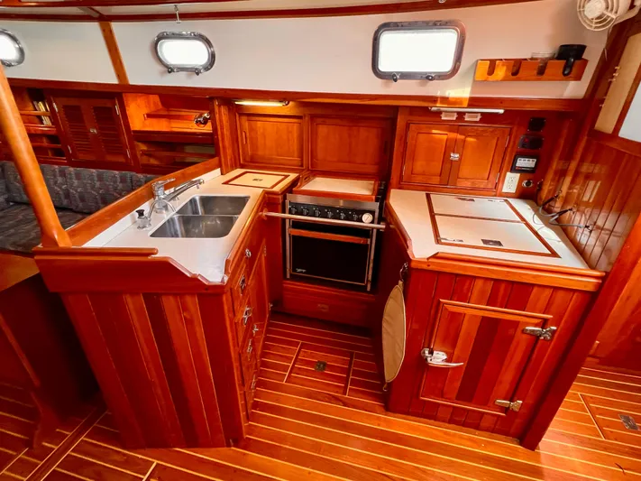 Glory Yacht Photos Pics Luxurious 2001 Shannon 43 Cutter yacht interior with wooden cabinetry and modern kitchen amenities.