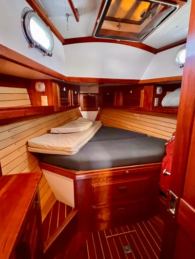 Glory Yacht Photos Pics Cozy cabin interior of 2001 Shannon 43 Cutter with wood paneling and comfortable bedding.
