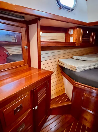 Glory Yacht Photos Pics Interior of 2001 Shannon 43 Cutter with wooden cabinetry and cozy sleeping area.