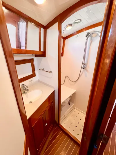 Glory Yacht Photos Pics Luxurious bathroom in 2001 Shannon 43 Cutter yacht with wooden accents and modern fixtures.