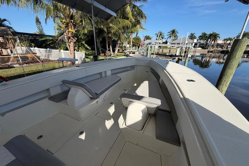  Yacht Photos Pics 2018 SeaVee 390Z boat interior with seating, docked near palm trees and calm water.