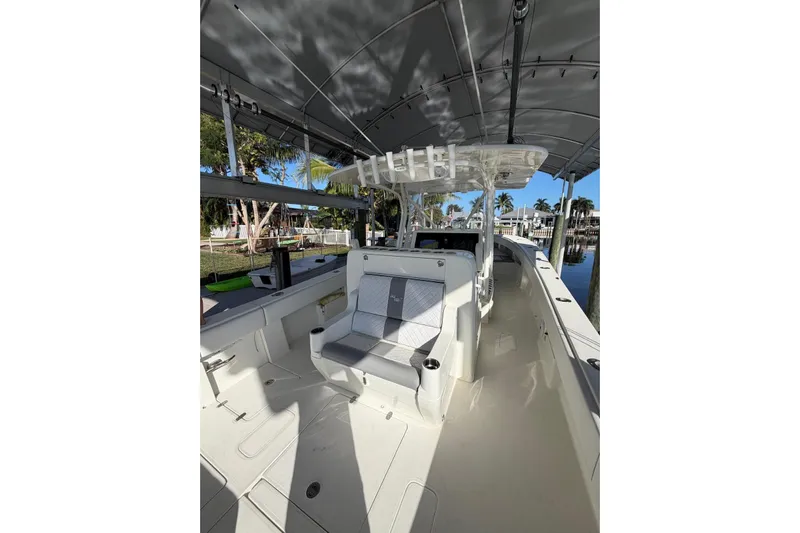  Yacht Photos Pics 2018 SeaVee 390Z boat interior with seating and canopy, docked by a waterfront.