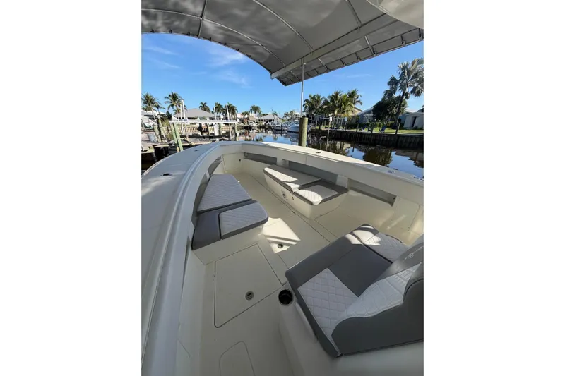  Yacht Photos Pics 2018 SeaVee 390Z boat interior with seating, docked by palm trees and calm water.