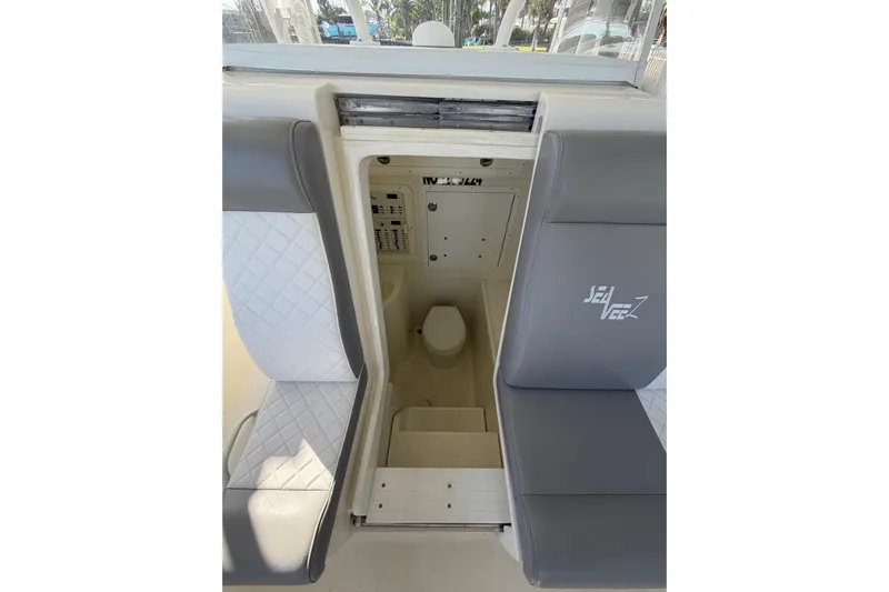  Yacht Photos Pics 2018 SeaVee 390Z boat interior with seating and compact toilet area.