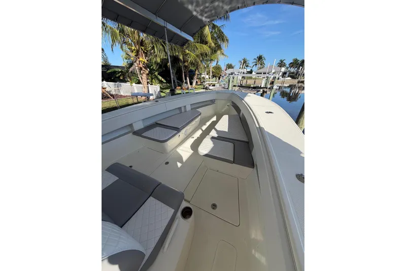  Yacht Photos Pics 2018 SeaVee 390Z boat interior with cushioned seating, docked near palm trees.