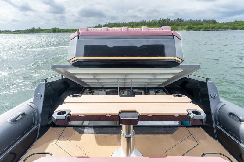  Yacht Photos Pics 2023 Skipper-BSK 42 boat with open storage compartment on a calm waterway.