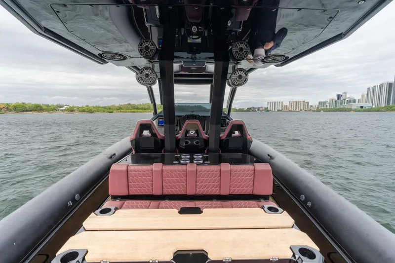  Yacht Photos Pics Luxury Skipper-BSK 42 boat interior, 2023 model, on water with cityscape background.