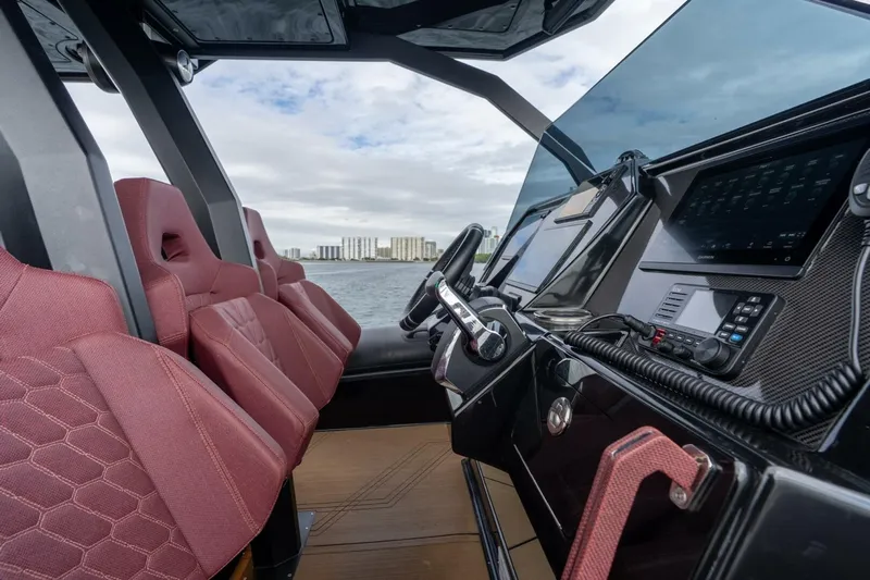  Yacht Photos Pics Interior of 2023 Skipper-BSK 42 boat with modern dashboard and red seats.