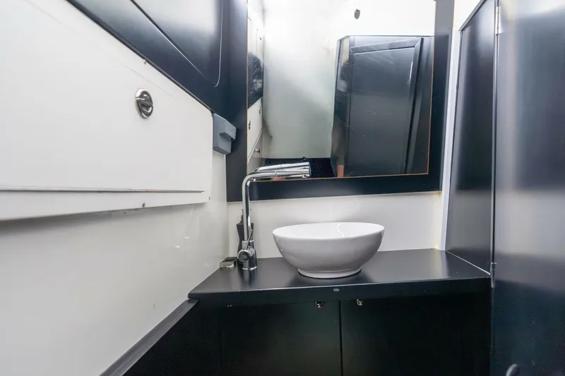  Yacht Photos Pics Modern bathroom interior in 2023 Skipper-BSK 42 yacht, featuring sleek sink and mirror.