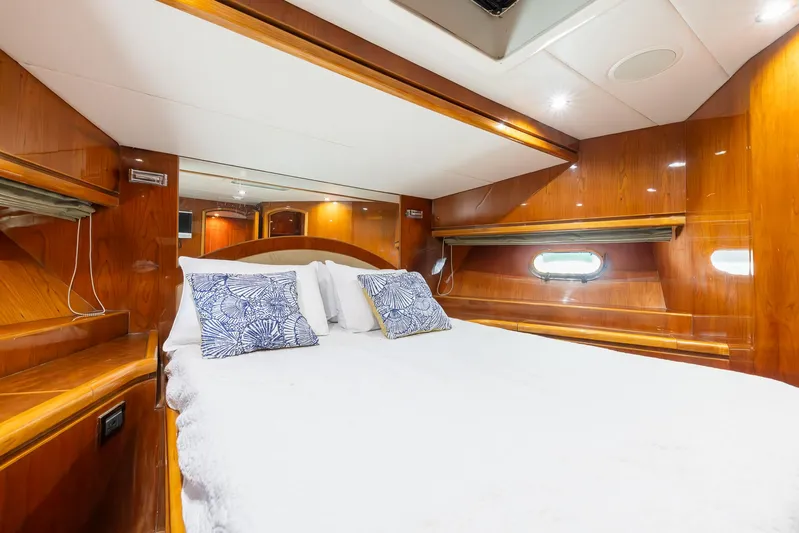 Ocean 1 Yacht Photos Pics Luxurious cabin interior of 2008 Hargrave Sky Lounge yacht with wood paneling and cozy bedding.