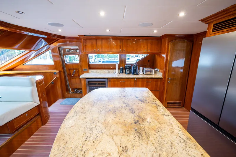 Ocean 1 Yacht Photos Pics Luxurious 2008 Hargrave Sky Lounge yacht kitchen with wood cabinetry and marble countertops.
