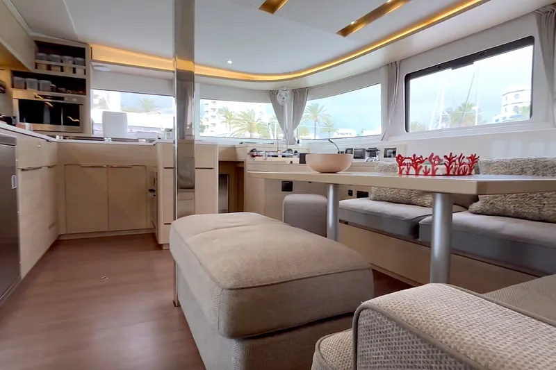  Yacht Photos Pics Luxurious interior of 2023 Lagoon 46 yacht with modern furnishings and panoramic windows.