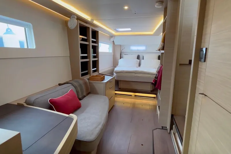  Yacht Photos Pics Luxurious interior of 2023 Lagoon 46 yacht with cozy seating and elegant bedroom.